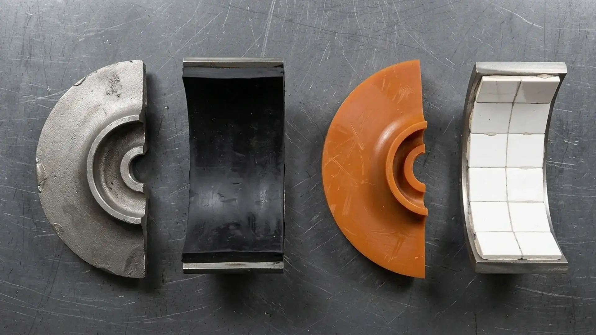 Side-by-side material samples of high-chrome iron, rubber lining, polyurethane, and ceramic tiles for slurry pump liner selection